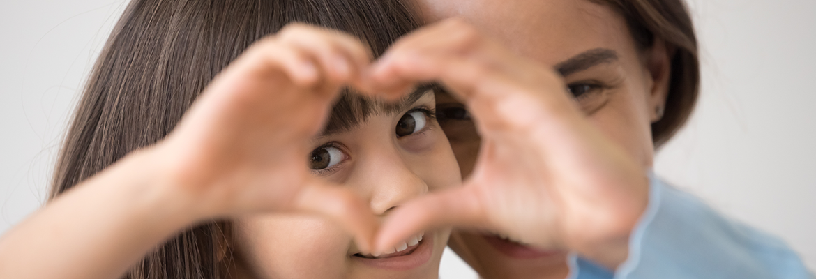 Mother and Child make heart symbol with hands