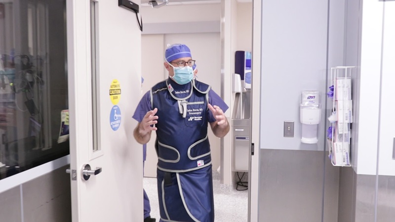 Joshua Marcus, MD, Neurosurgeon and Chief of Neurointerventional Surgery at Danbury Hospital and Norwalk Hospital, walking into the Biplane Angiography Suite where they treat stroke patients.