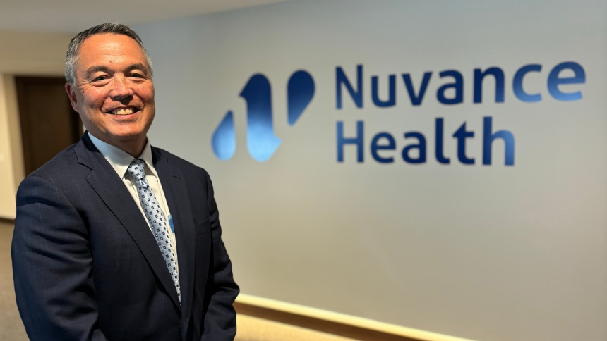 Dr. Alan Kurose standing in front of the Nuvance Health logo.