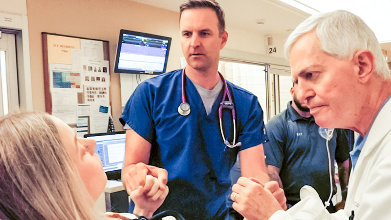 Emergency medicine physician and neurology evaluate a young, female patient for stroke symptoms in the emergency department