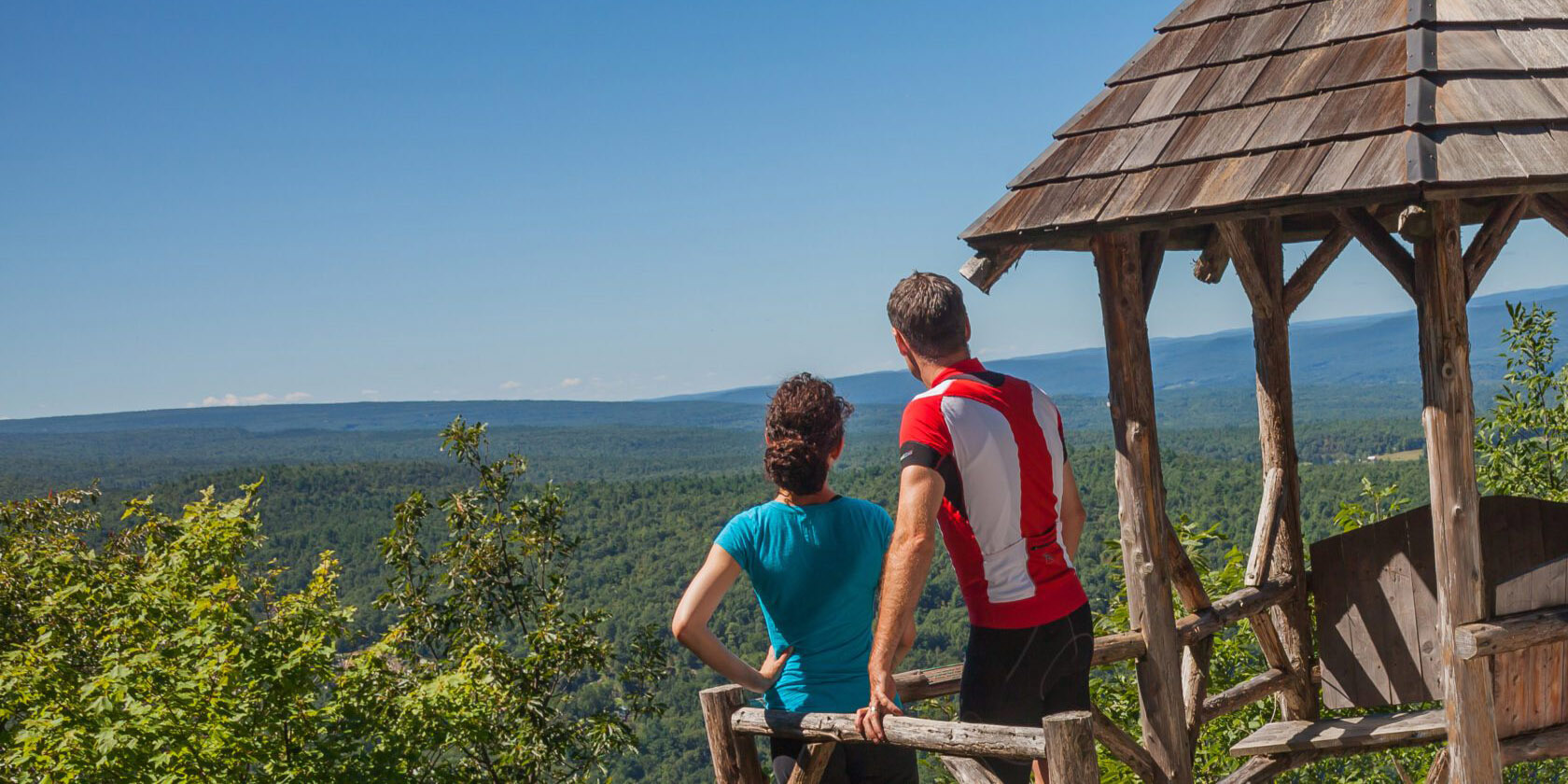 A couple looking out over a mountain range.