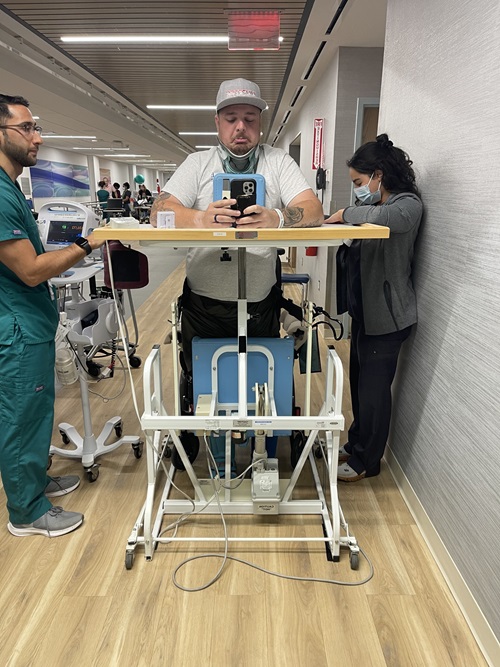 Samuel Neelands, Danbury Hospital spine surgery patient, sitting in a wheelchair in a hospital room as he prepares to leave the hospital.