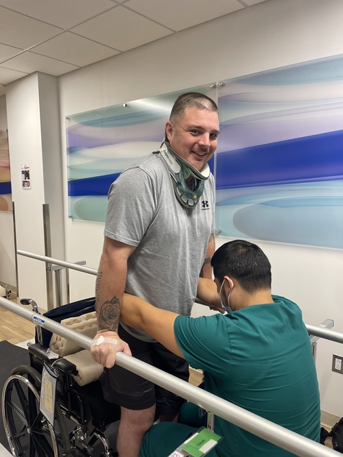 Samuel Neelands, Danbury Hospital spine surgery patient at an acute inpatient rehabilitation unit learning to walk using parallel bars.