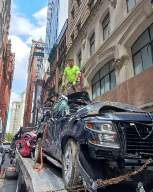 Samuel Neelands, Danbury Hospital spine surgery patient, standing on top of cars on a heavy operator. 