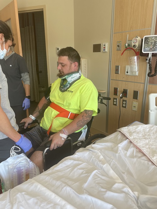 Samuel Neelands, Danbury Hospital spine surgery patient, sitting in a wheelchair in a hospital room as he prepares to leave the hospital.