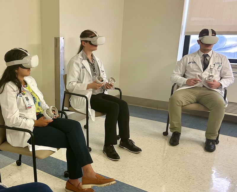 Vassar Brothers Medical Center neurology residents wearing VR headsets. They participated in the Nuvance Health study, where over 85% of participants reported reduced anxiety and recommended VR as a relaxation tool.