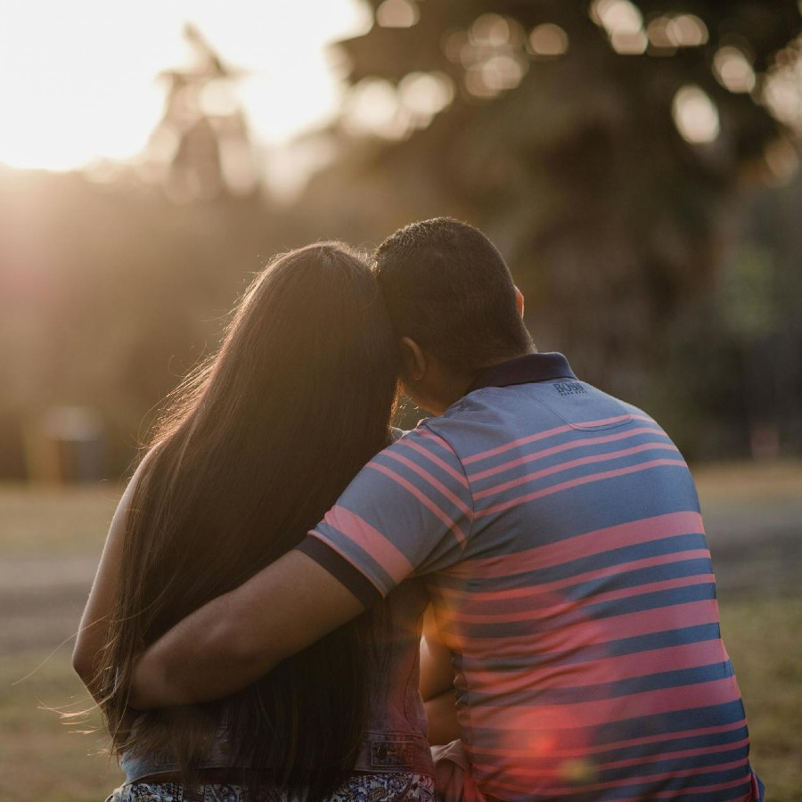 Man embracing woman