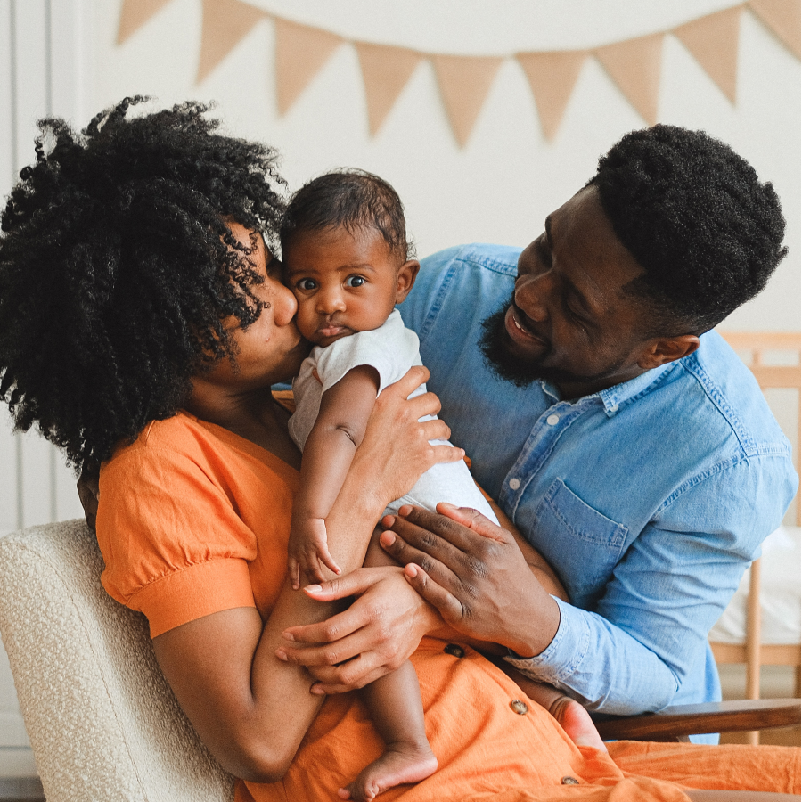 Woman Kissing a baby beside a man