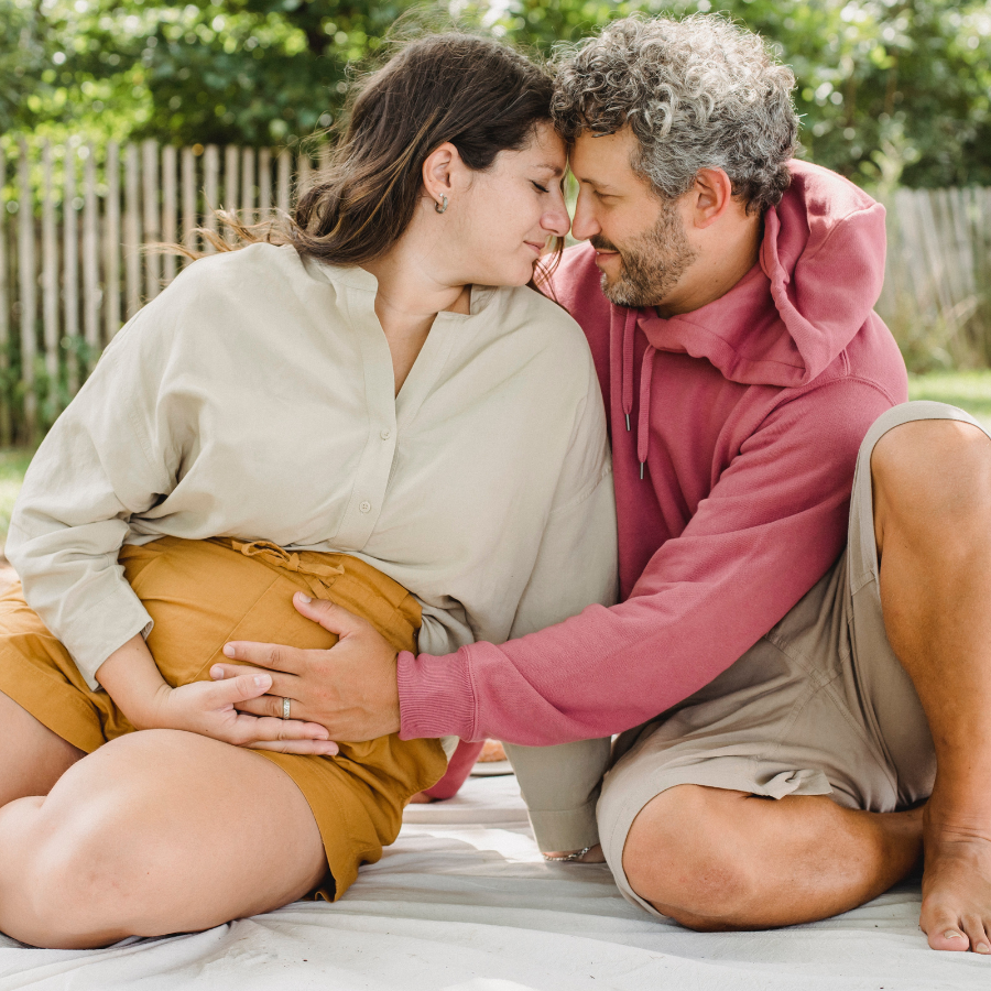 Loving husband holding pregnant wifes belly