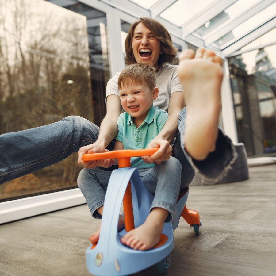 Mother and son riding a toy car