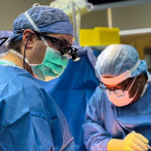 Neurosurgeons Dr. Jeffrey Gilligan (left) and Dr. Ramon Batson (right) operating on a spine surgery patient in the Danbury Hospital OR.