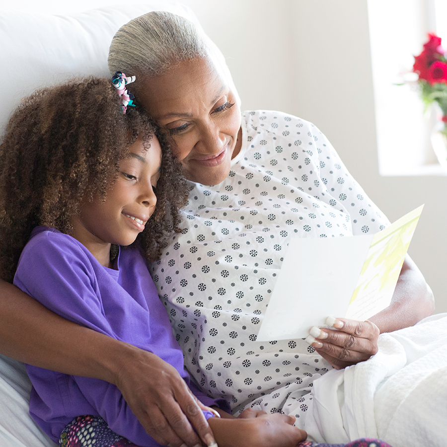 older female patient reads card from granddaughter