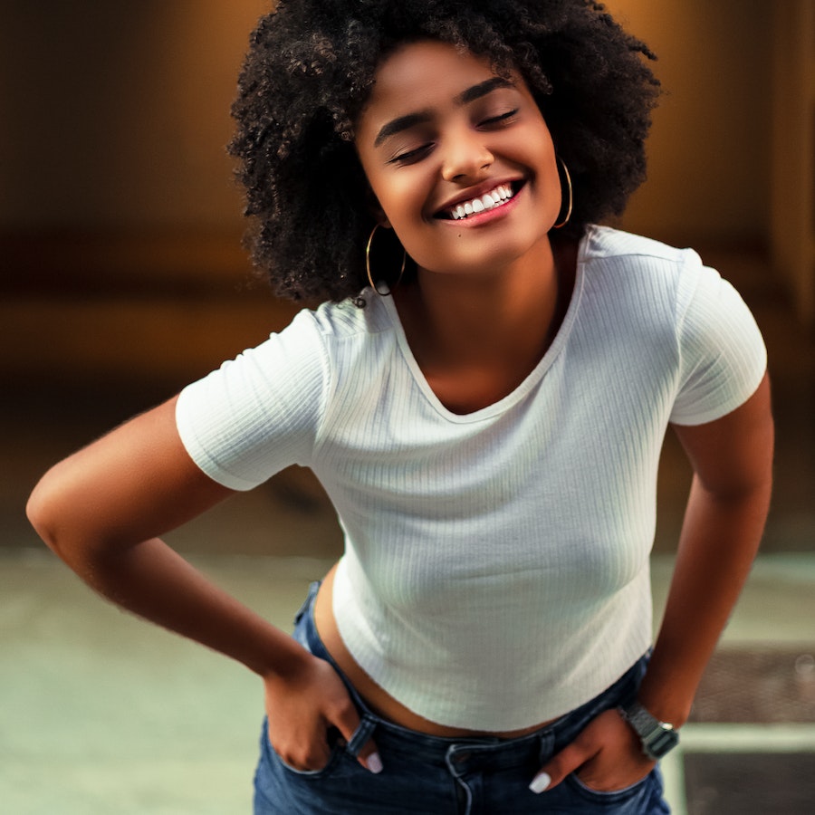 African american woman smiling in a white tee