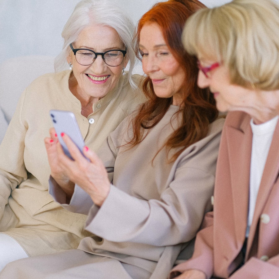 Happy elderly women looking at a cell phone