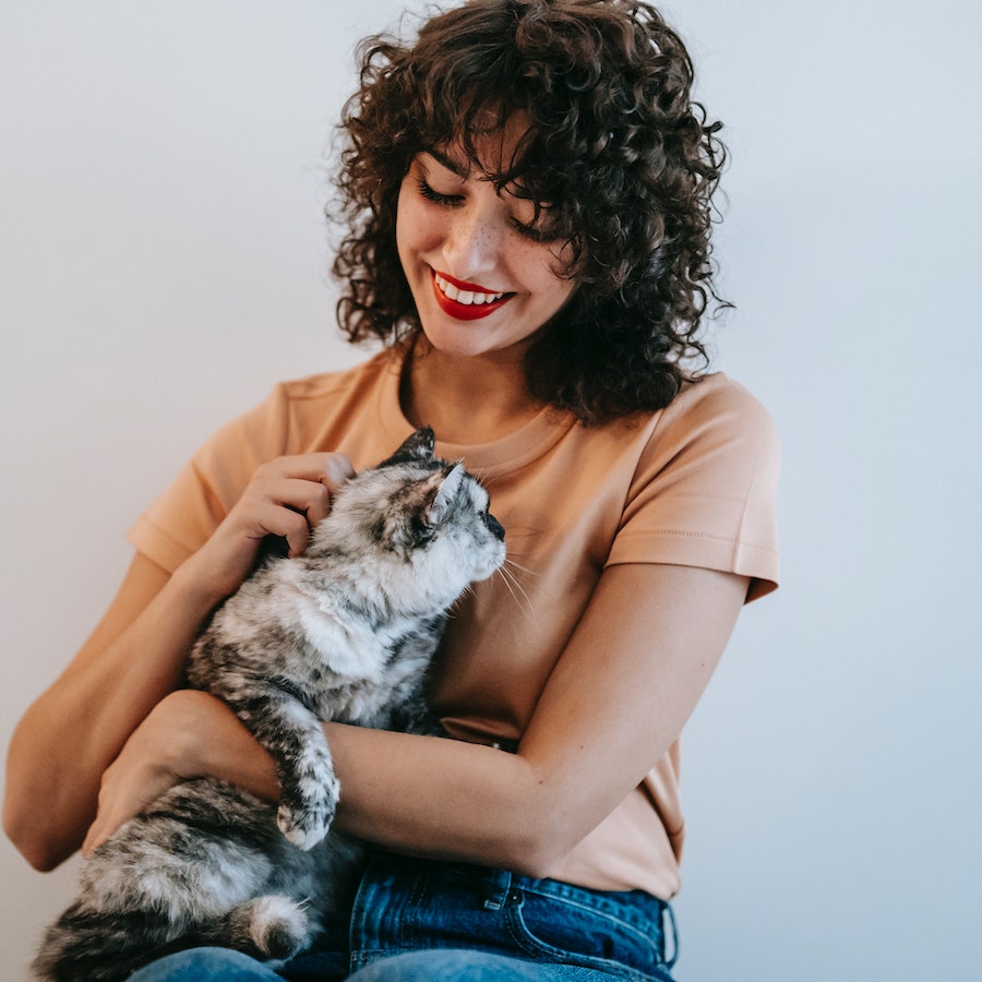 Happy woman holding a cat
