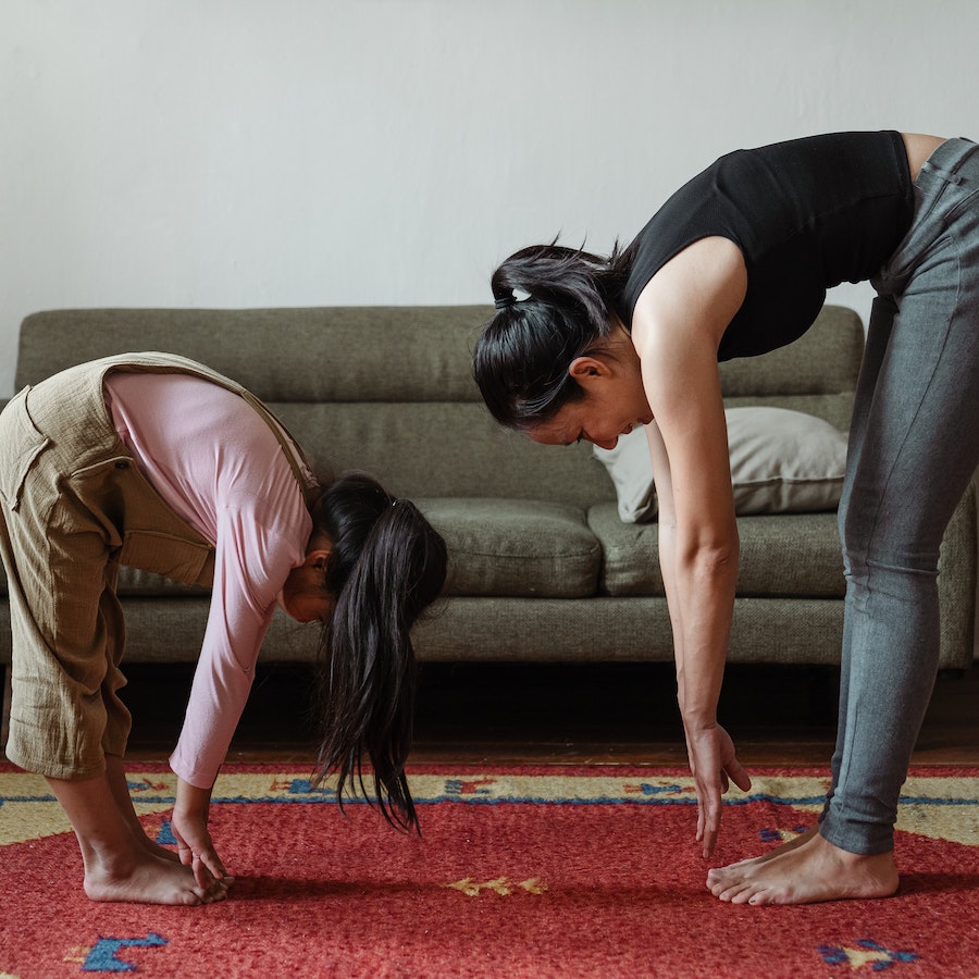 Woman and girl stretching