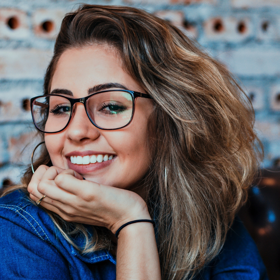 Woman smiling wearing a blue denim jacket